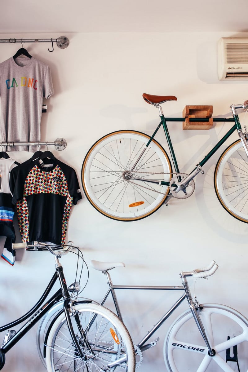 Bikers, Challenge Yourself! National Bike Month 2022 Goal - One Ride Per Day bicycles near wall with clothes