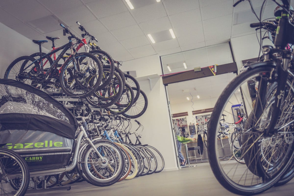 Buying From Local Bike Shops Versus The World Wide Web? bicycle hanged and piled on bicycle shop